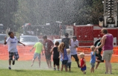 Kids sprayed by water hoses